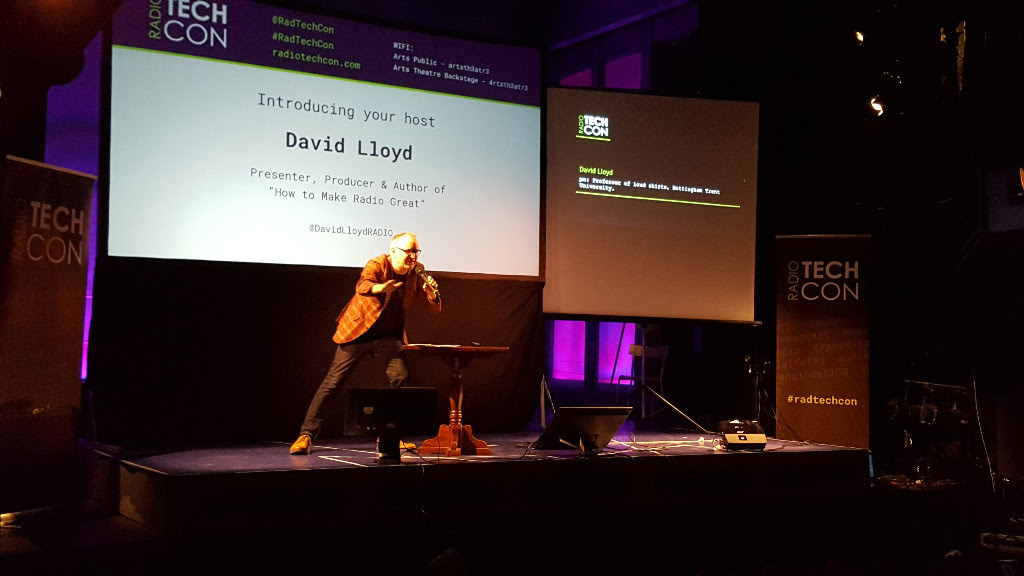 David Lloyd performing a lunge on stage as he opens Radio TechCon 2016